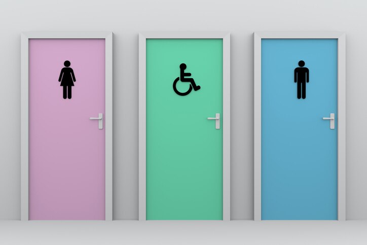 three toliet doors for women, disabled persons and men. Each one has his own pictogram