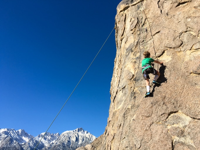 Young child plays and climbs near Mt Whitney, California