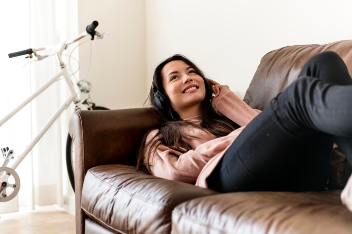 Girl listening to music at home on the sofa