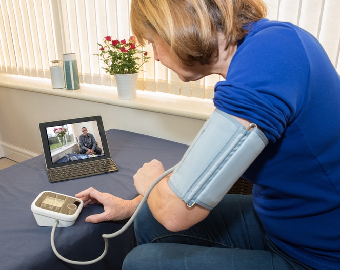 Patient communicates with her doctor via a laptop for advice - telehealth