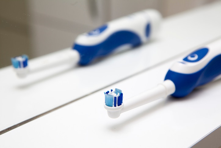 Cropped shot of a handsome young man and his son brushing their teeth in the bathroom