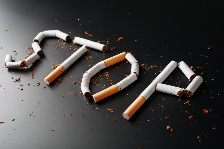 The inscription STOP from cigarettes on a black background. Stop smoking. The concept of smoking kills. Motivation inscription to quit smoking, unhealthy habit. Smoking as a deadly habit, nicotine poison, cancer and smoking