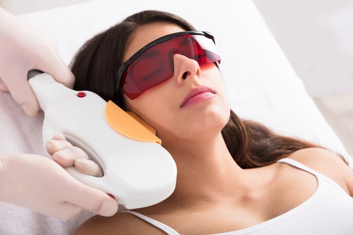 Young Woman Receiving Laser Epilation Treatment On Cheek In Beauty Spa