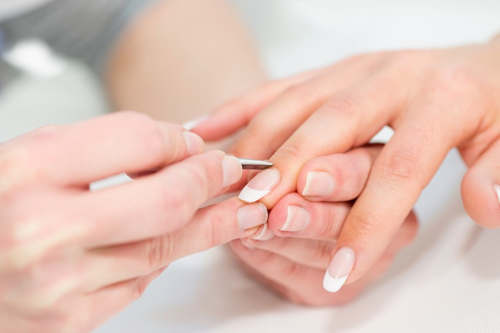 manicuring hands - pushing cuticles