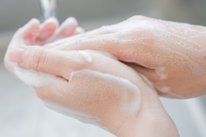 Woman washing her hands.