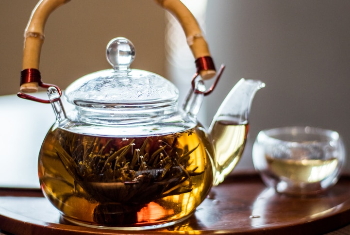 Jasmine tea flower in a traditional glass teapot with a bamboo handle in Shanghai, China