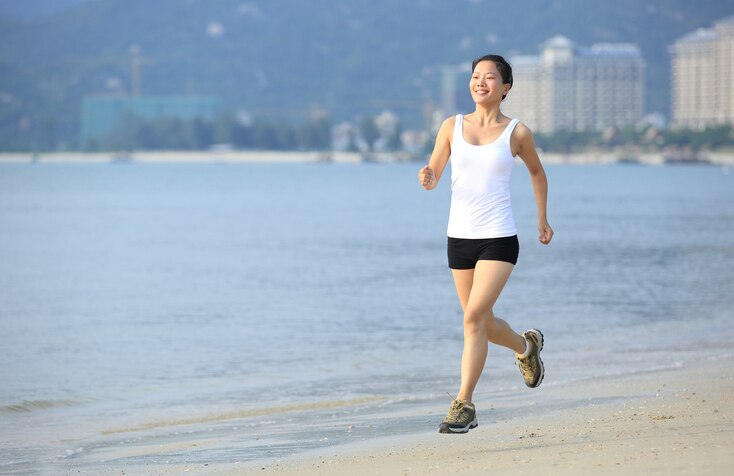 young asian woman runner seaside