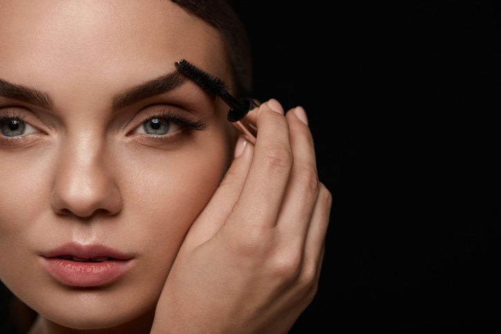 Woman Makeup. Closeup Of Young Female Model Face With Smooth Soft Healthy Skin And Fresh Make-up. Beautiful Girl Hand With Eyebrow Gel Brush For Eyebrows. Beauty Tools. High Resolution Image