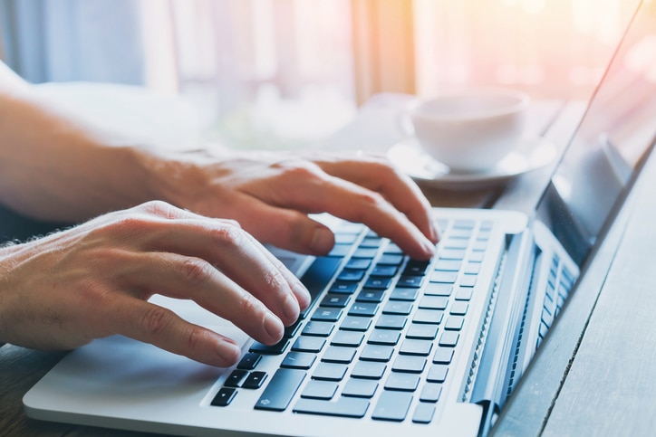 close up of hands of business person working on computer, man using internet and social media