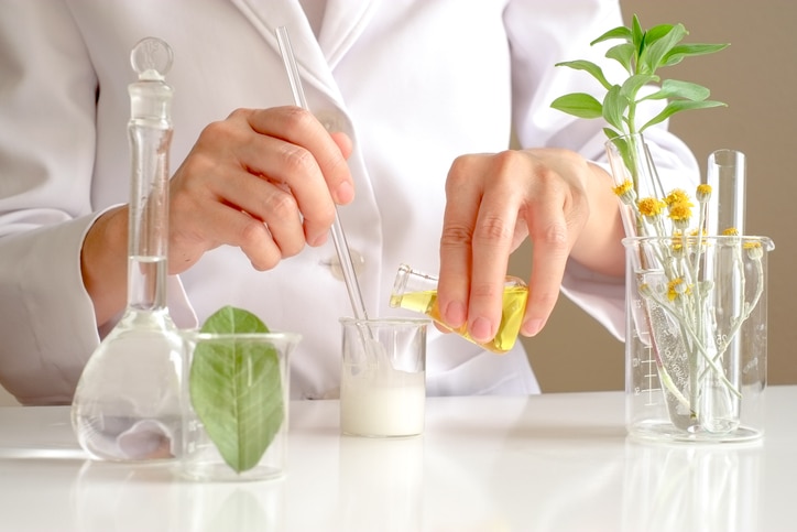 the scientist,dermatologist testing the organic natural product in the laboratory.research and development beauty skincare concept.blank package,bottle,container .cream,serum.hand