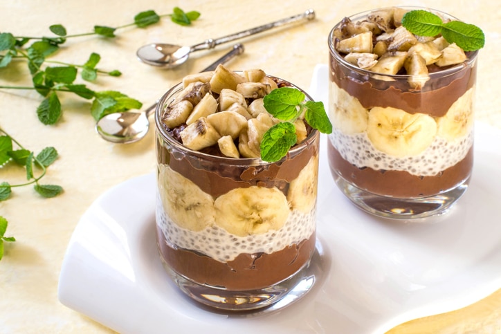 Chia pudding with chocolate and banana on yellow background. Cleansing, diet, healthy food, fitness concept. Antioxidant, superfood, ideal for breakfast. Vertical, selective focus