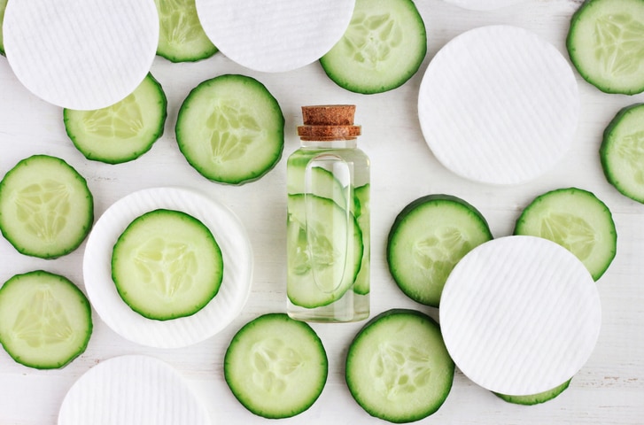 green cucumber slices, cotton-pads, top view ingredients.