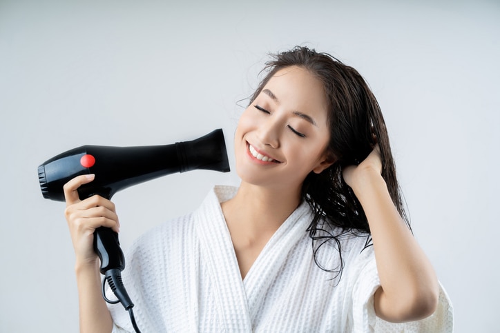 Asian woman drying your hair after showering