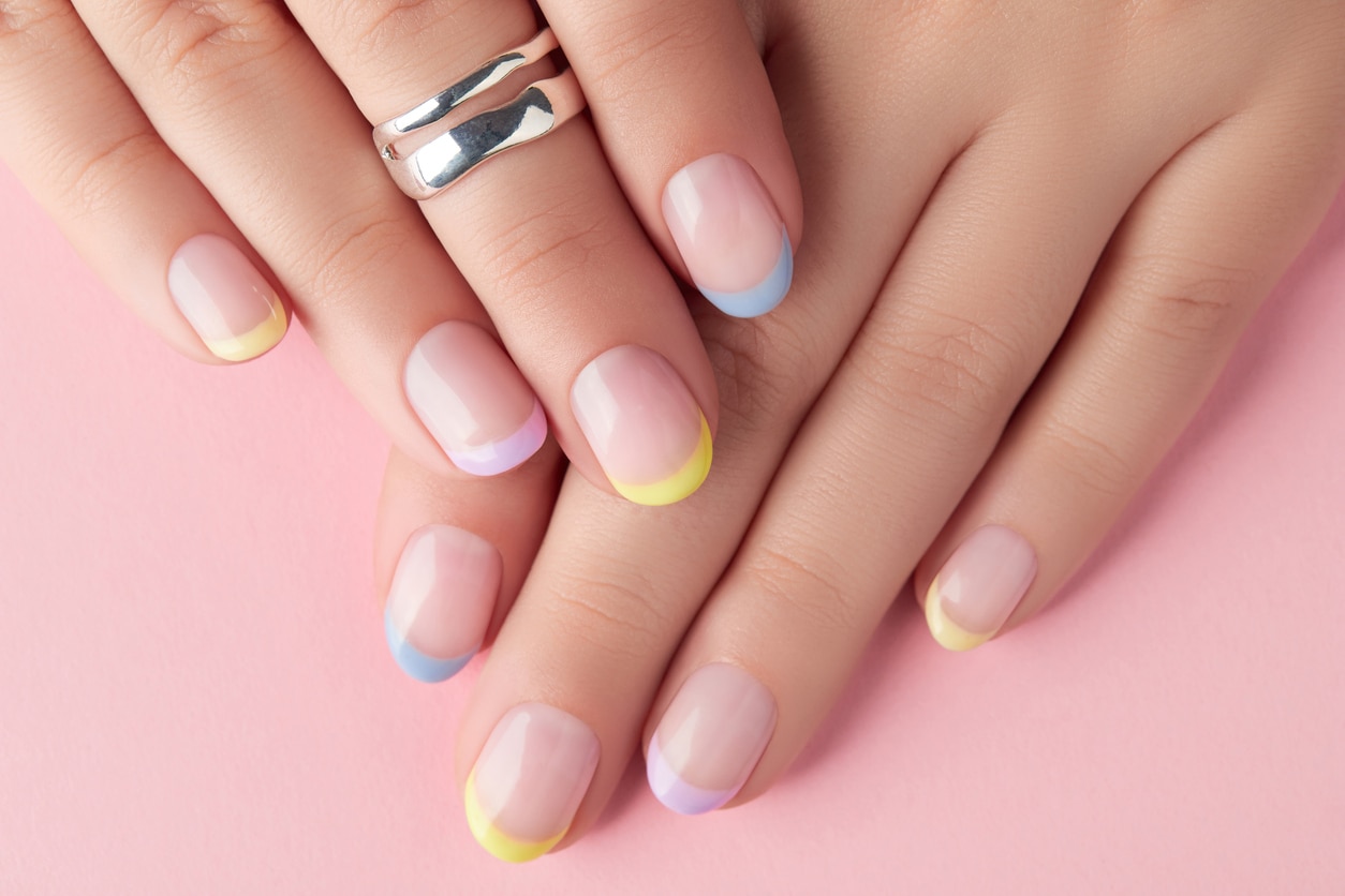 Close up manicured womans hands on pink background. Manicure, pedicure spring summer design trends, nail art design ideas for spring & Valentine’s Day