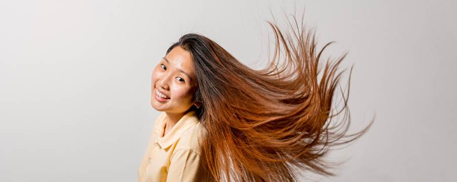 A person with her hair blowing in the wind
AI-generated content may be incorrect.
